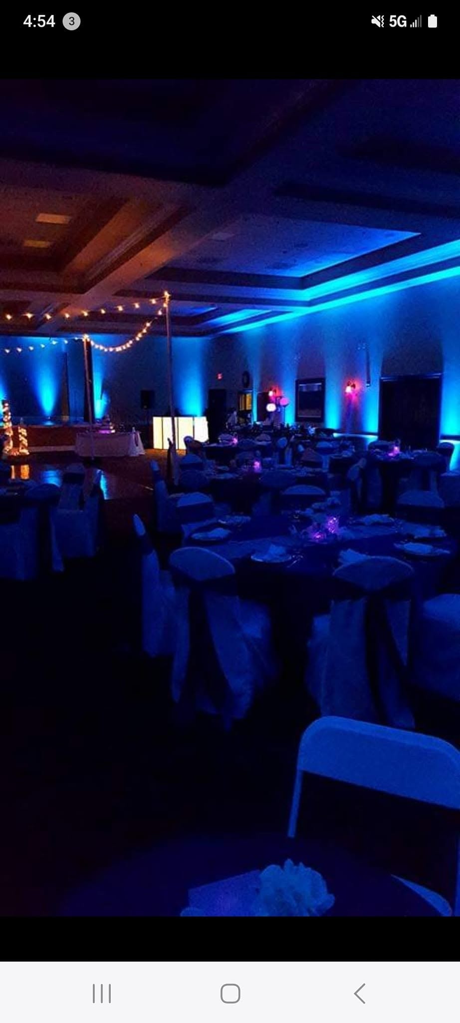 Elegant pipe and drape backdrop with LED runway lighting at event venue